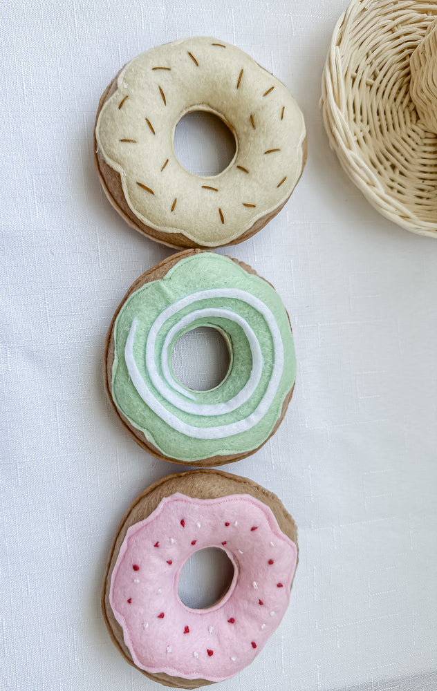 Set of three different coloured donuts with freckles