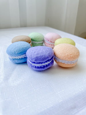 Set of seven felt tea party rainbow coloured macarons in  a circle from a side view