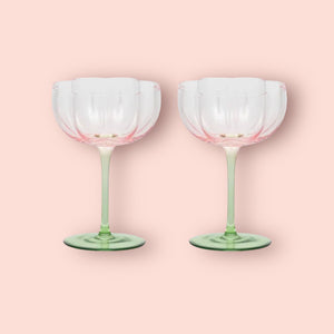 Pink tulip shaped top and green stemmed wine glasses