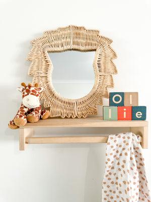 Rattan Lion Mirror displayed on shelf with other toys