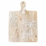 Wooden paddle with etched palm trees and a tassel