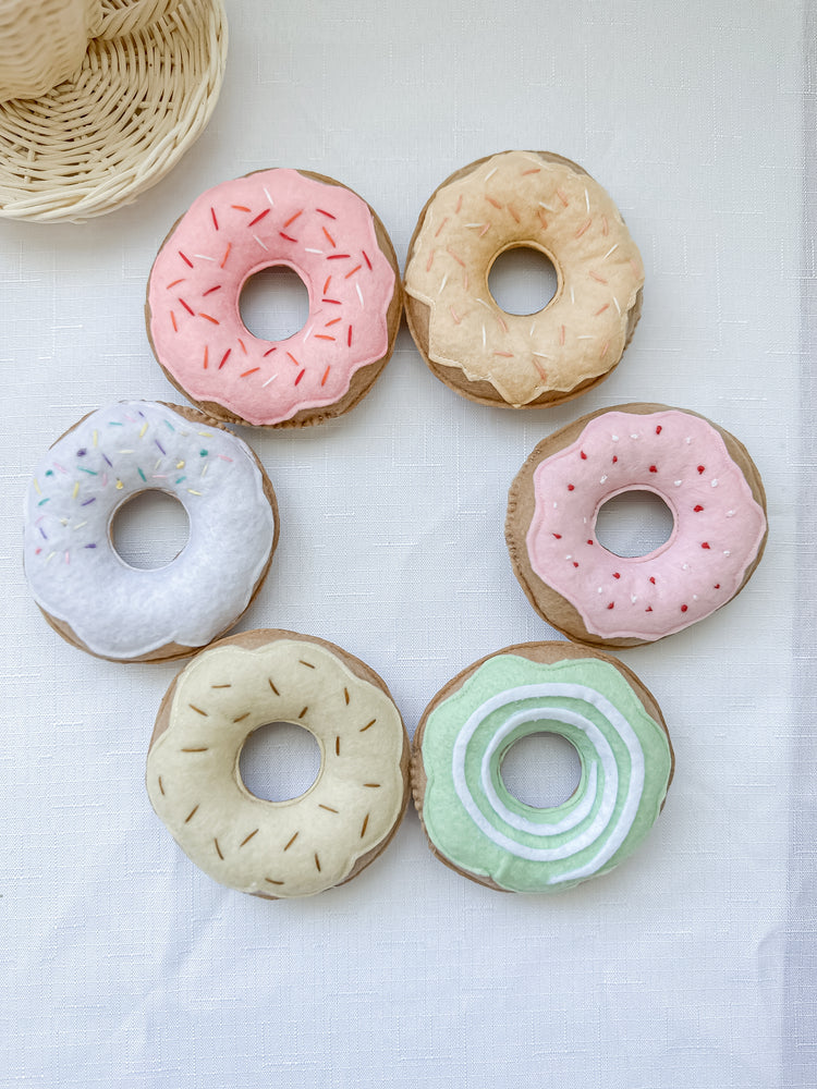 Set of six different coloured donuts with freckles in a circle