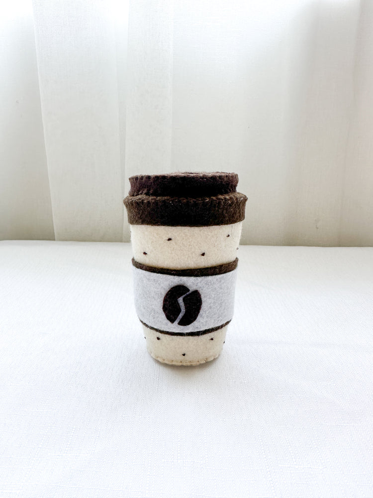 Felt coffee cup with lid in mocha colour, dotted pattern top and bottom with coffee bean design on front.