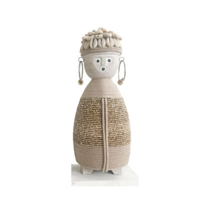 beige doll with macramé body, shell hat and earrings with beads on a wooden stand