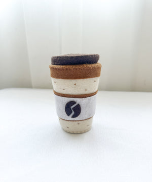 Felt coffee cup with lid in latte colour, dotted pattern top and bottom with coffee bean design on front.