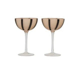 Wine glasses in nude and black on white background