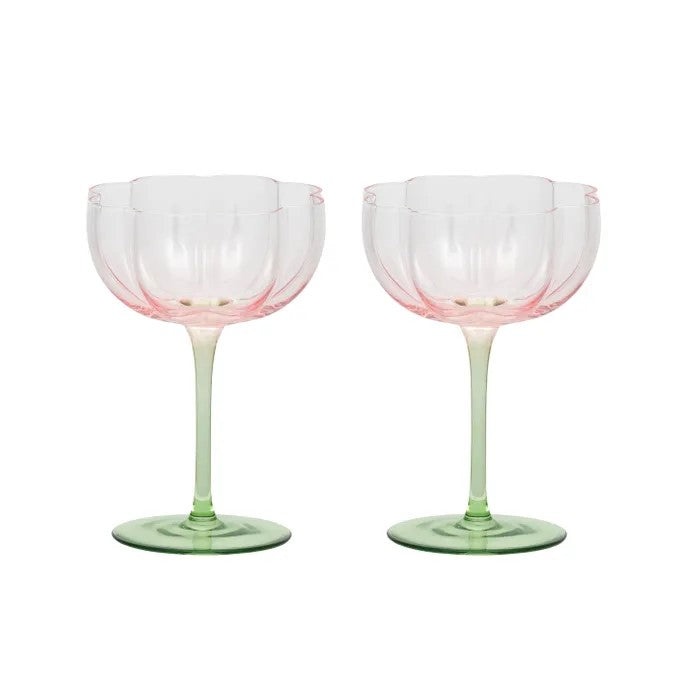 two pink tulip cups and green stemmed glasses