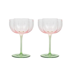 two pink tulip cups and green stemmed glasses