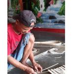 Local craftsman from Indonesia working on rattan products.