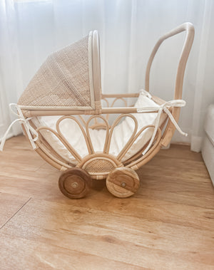 Detail view of handmade rattan play dolls pram Violet showing foam linen insert - premium Balinese artisan children's toy with teak wooden wheels