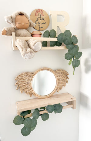 Rattan koala mirror Ralf styled on shelf in children's room with toys - handmade Indonesian nursery decor adding whimsy and character to kids' spaces, wall-mountable or shelf display