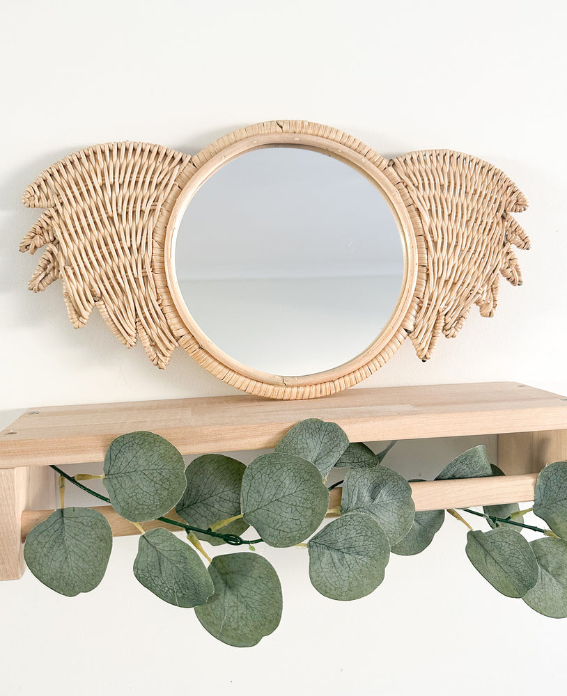 Rattan koala mirror Ralf displayed on shelf - handmade Indonesian nursery decor piece featuring natural rattan frame and functional mirror for children's rooms