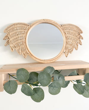 Rattan koala mirror Ralf displayed on shelf - handmade Indonesian nursery decor piece featuring natural rattan frame and functional mirror for children's rooms