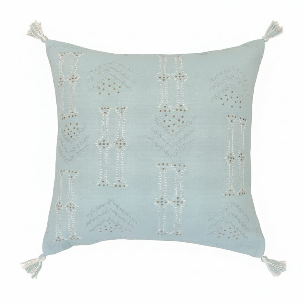 Light blue pillow with geometric patterns and tassels on a white background
