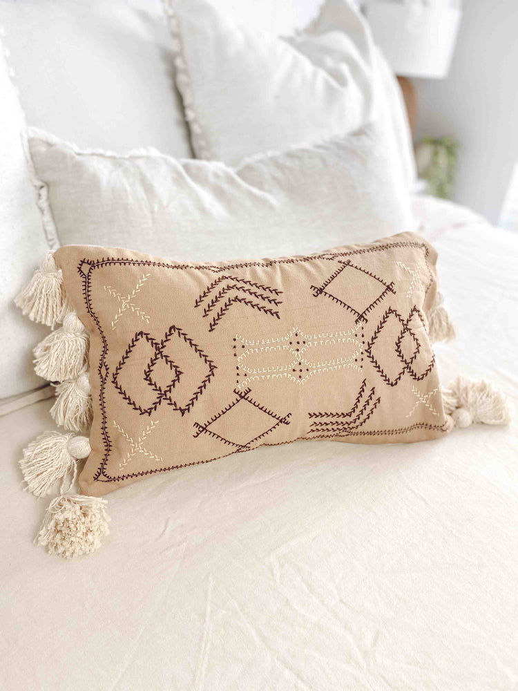 lumbar cushion cover with tassels on bed