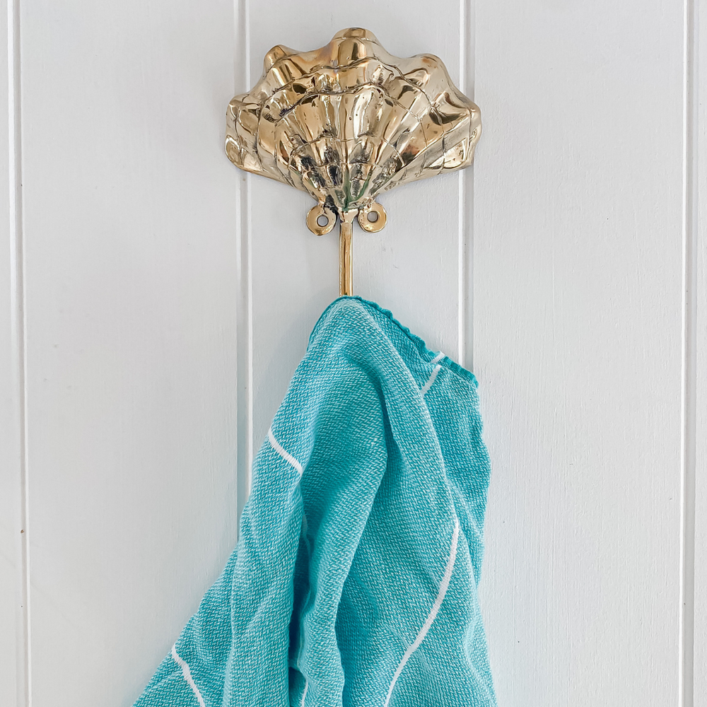 brass shell hook holding blue scarf