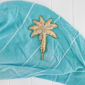 Brass Palm Tree hook displayed on blue scarf