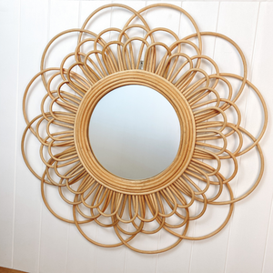 Round rattan mirror on wall