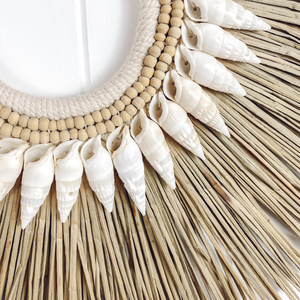 close up of handmade seagrass and shell wall hanging