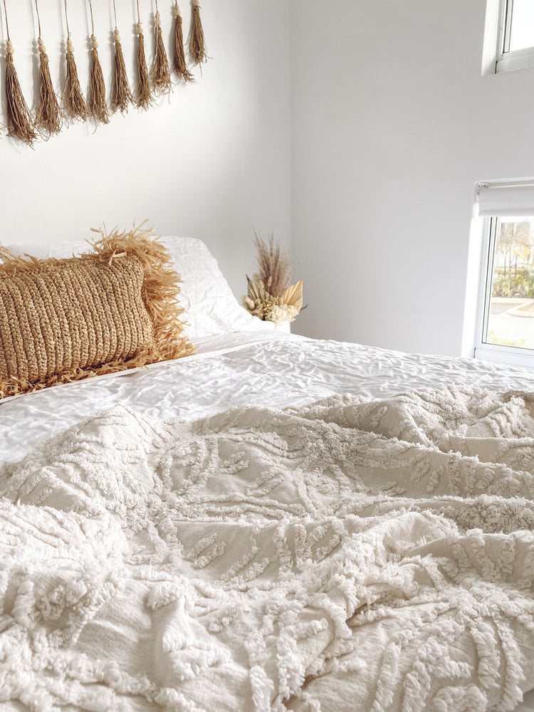 Darcie white tufted cotton throw rug styled on bed creating cozy bedroom sanctuary - 100% cotton 125x150cm