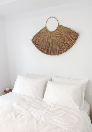 large hand made seagrass wall hanging on bedroom wall