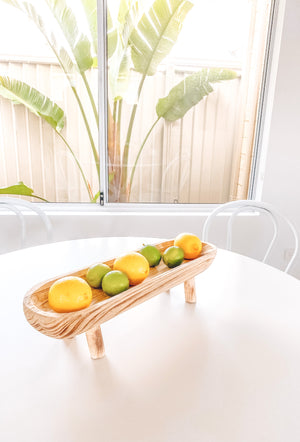 Natural Paulownia wooden dish displayed with lemons and limes