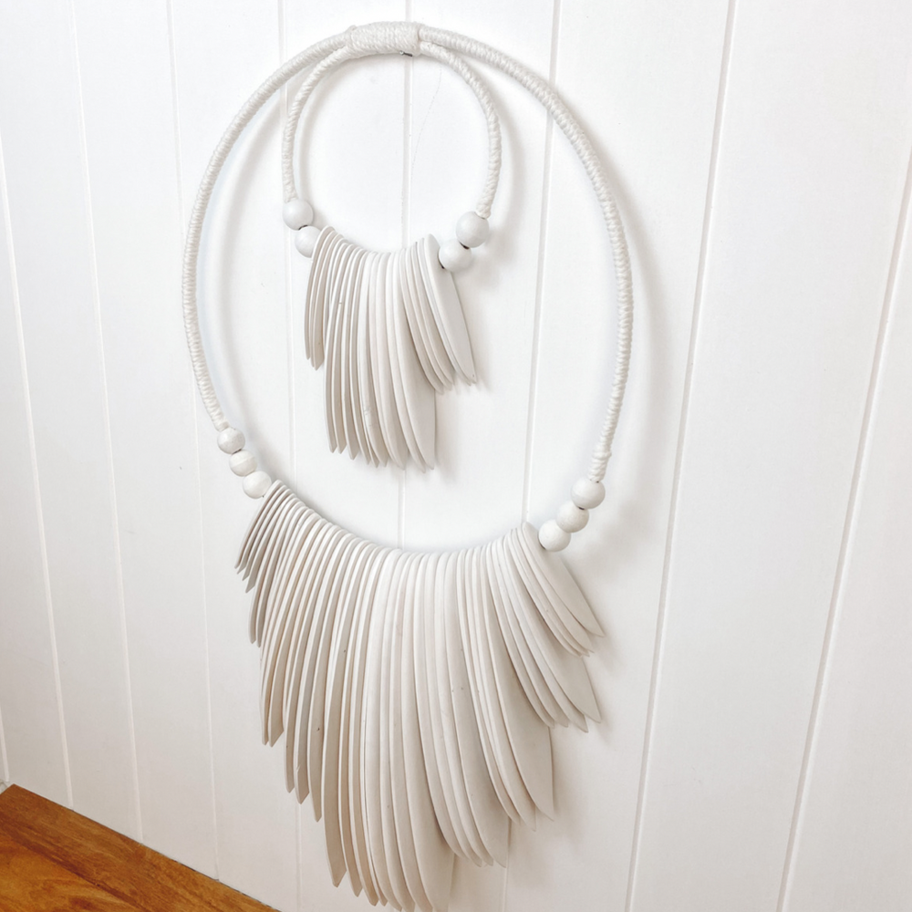 white timber with beads wall hanging on wall