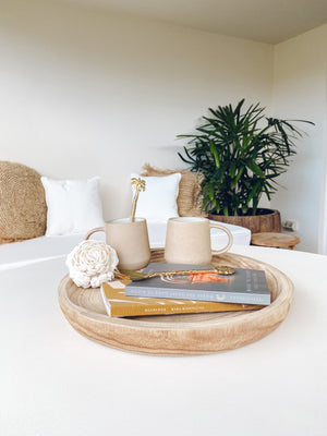 Rose shell ball displayed on a decorative wooden tray
