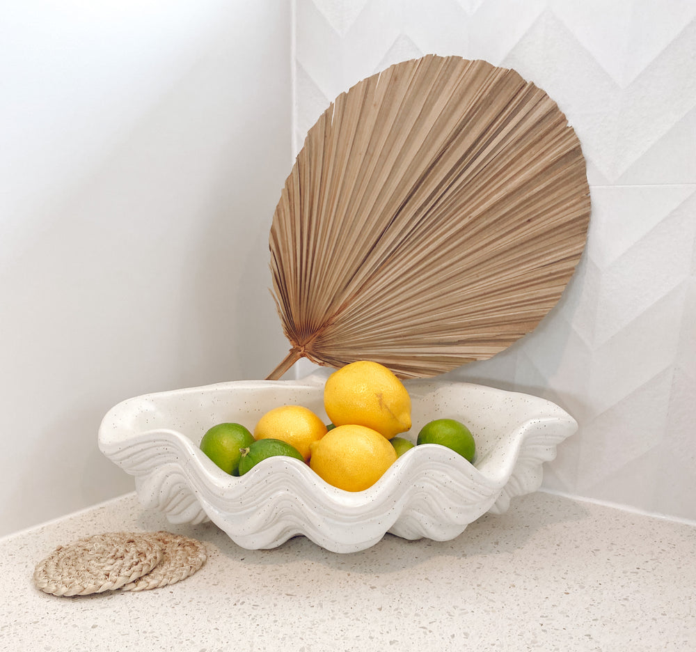 Large ceramic clam bowl displayed with fruit
