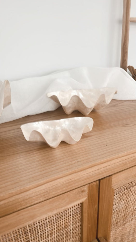 Clam capiz shell bowls displayed on bedside table