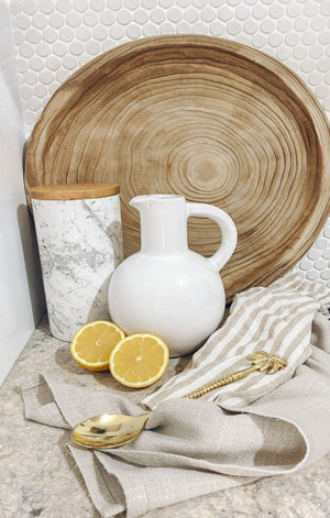 ceramic vase with handle displayed on kitchen bench