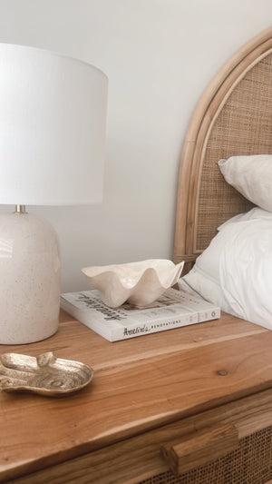 Clam capiz shell bowl displayed on bedside table