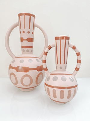 large and small pink ceramic vases with round handles