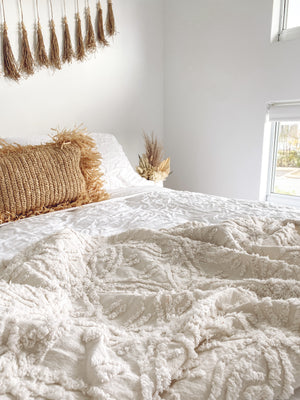 Cotton tufted throw on bed