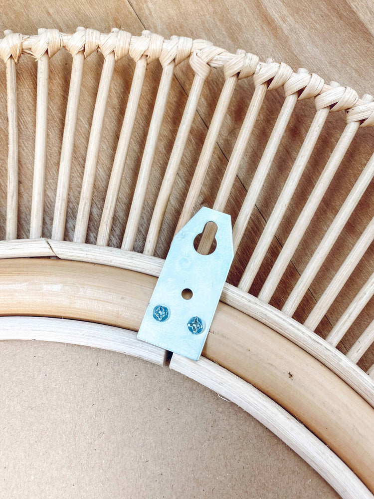 Kaelin rattan mirror back view showing sturdy metal wall hook for easy installation and secure mounting
