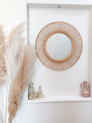 Kaelin rattan mirror displayed in wall nook with neutral decor, demonstrating versatile bohemian coastal style integration