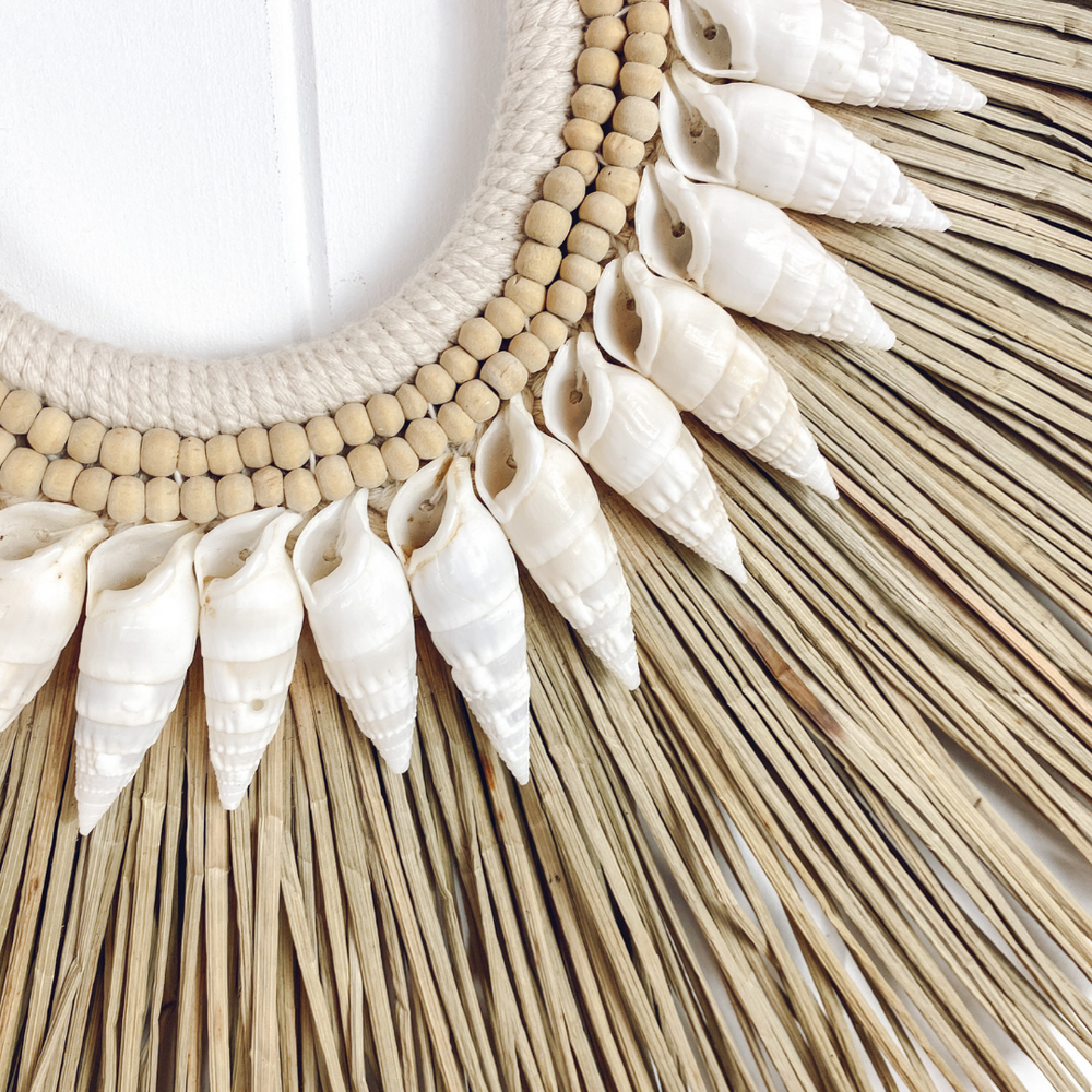 Close up detail of handmade seagrass and shell wall hanging - artisan crafted coastal home decor with natural texture