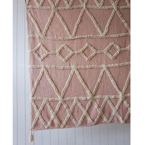 Tufted cotton blush throw rug texture pattern detail with tassels
